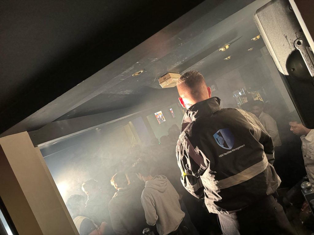 Crowded venue with security personnel